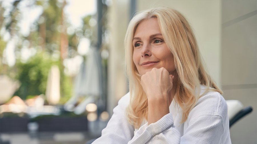 A confident woman in her fifties outdoors, representing menopause and perimenopause care at Florida Aesthetics and Wellness in Brandon FL