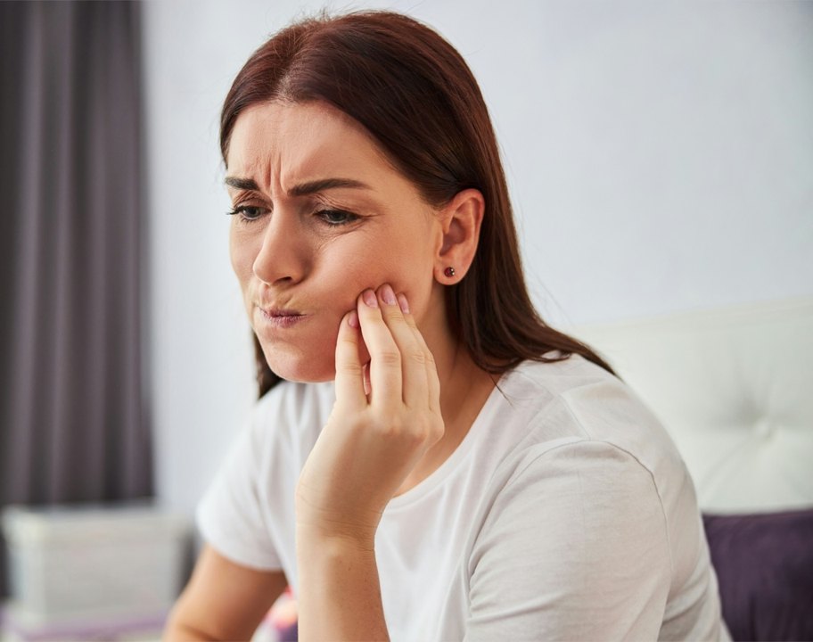 Woman with jaw pain seeking TMJ relief at Florida Aesthetics and Wellness Brandon FL