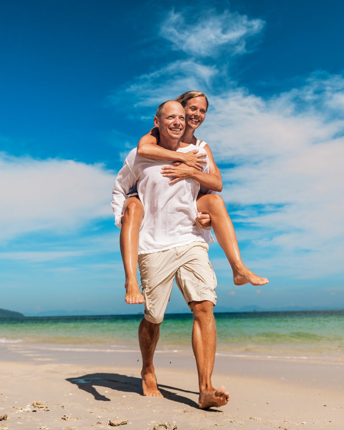 An active, happy couple on the beach near Brandon FL